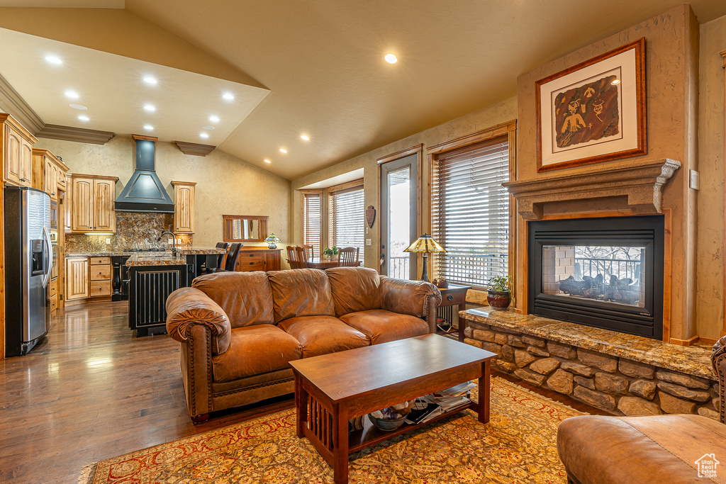 Living area featuring recessed lighting, wood finished floors, a multi sided fireplace, and vaulted ceiling