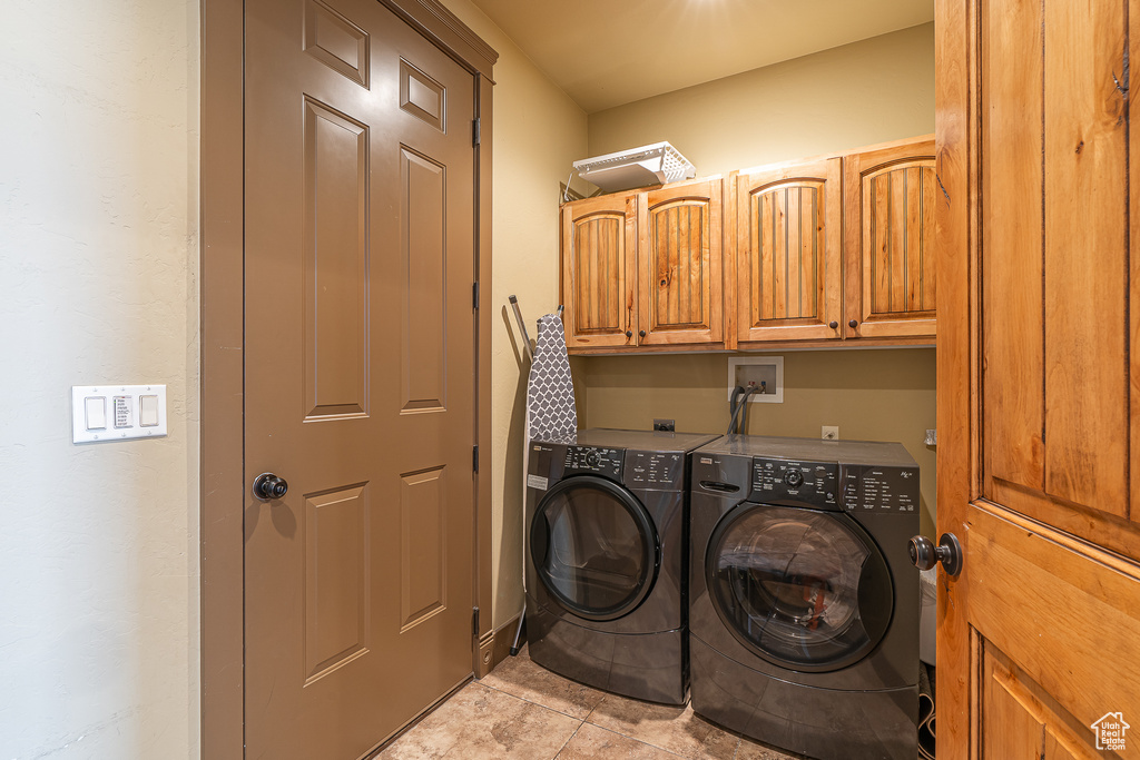 Laundry room with separate washer and dryer and cabinet space