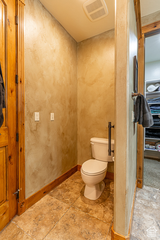 Bathroom with toilet and visible vents