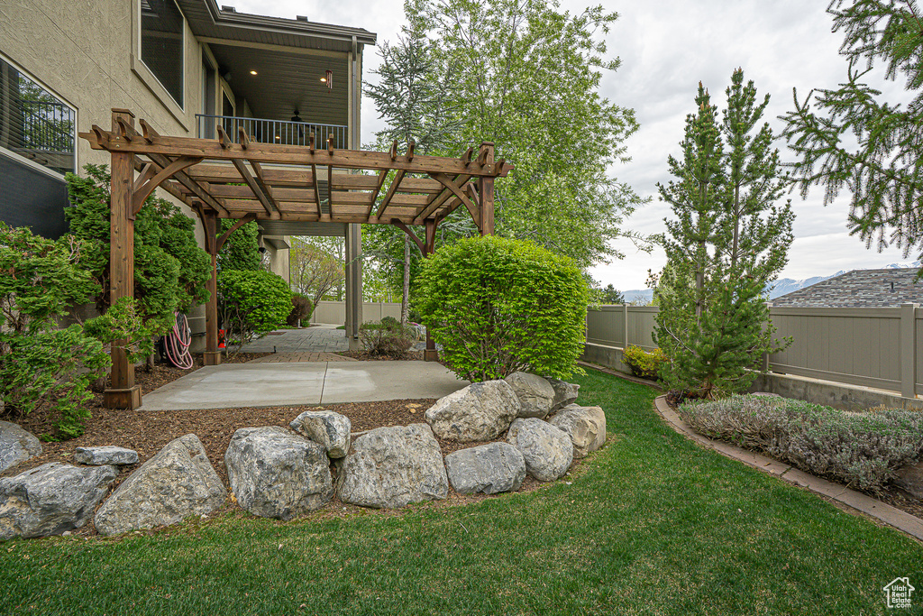 View of yard with a fenced backyard, a pergola, and a patio area