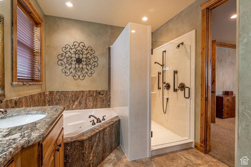 Full bathroom featuring a stall shower, a tub with jets, recessed lighting, and vanity