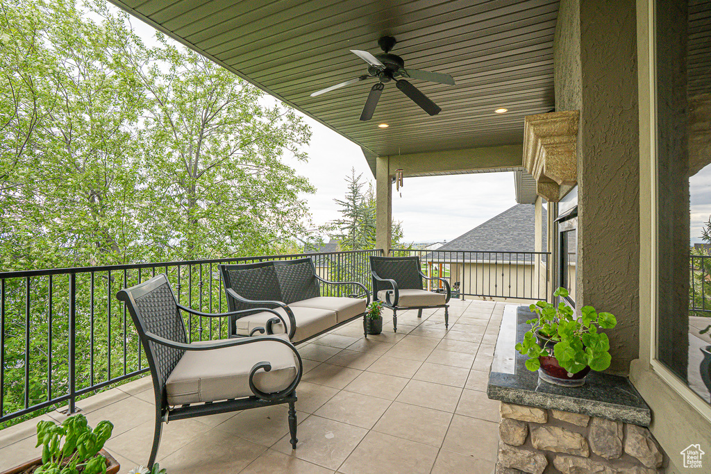 View of patio with a balcony and ceiling fan