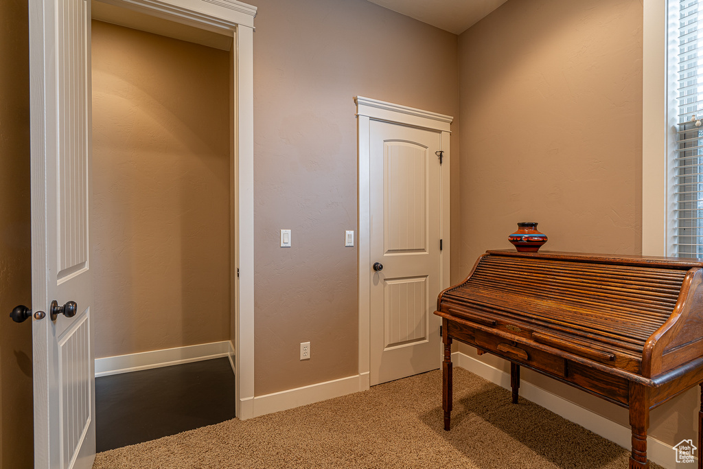 Interior space featuring light carpet and baseboards