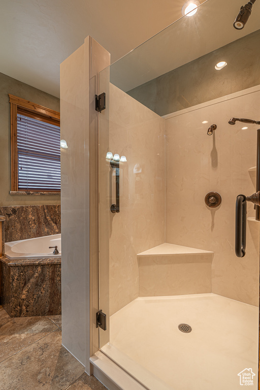 Bathroom with a garden tub and a shower stall