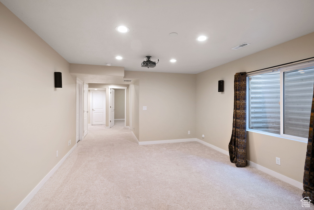 Spare room with recessed lighting, baseboards, visible vents, and light colored carpet