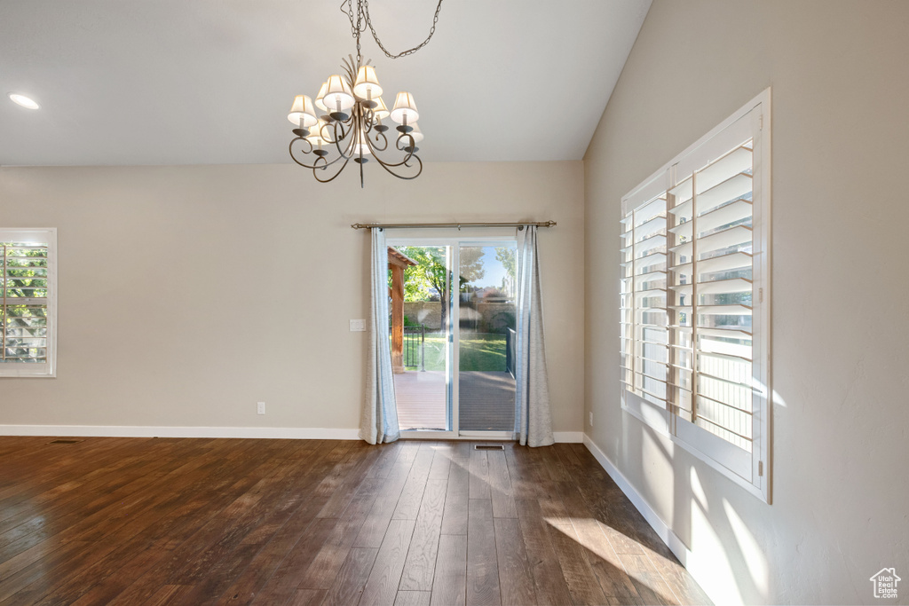 Unfurnished dining area with recessed lighting, baseboards, a chandelier, and dark wood-style floors