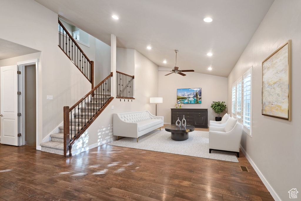 Living area featuring wood-type flooring, stairway, baseboards, ceiling fan, and recessed lighting