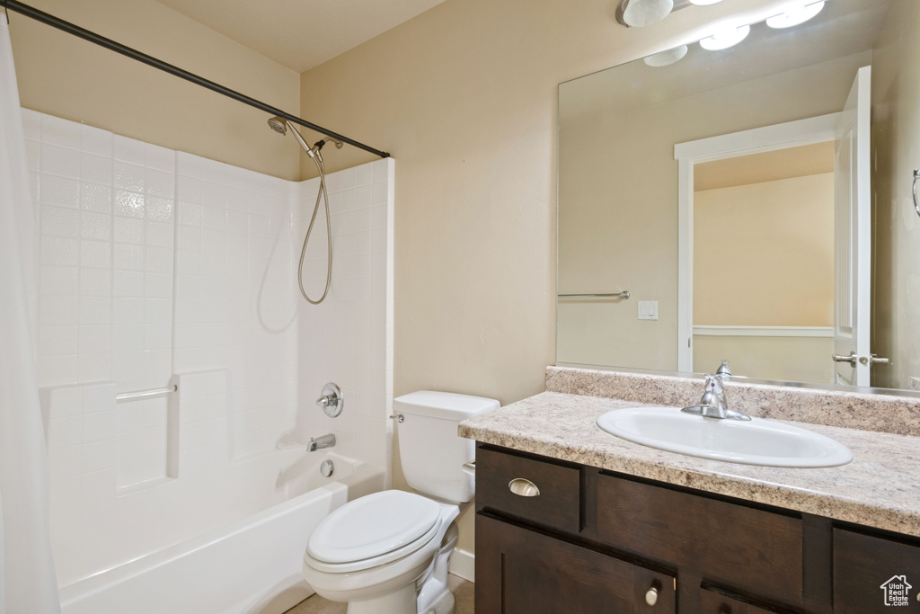 Bathroom featuring vanity, shower / bathing tub combination, and toilet