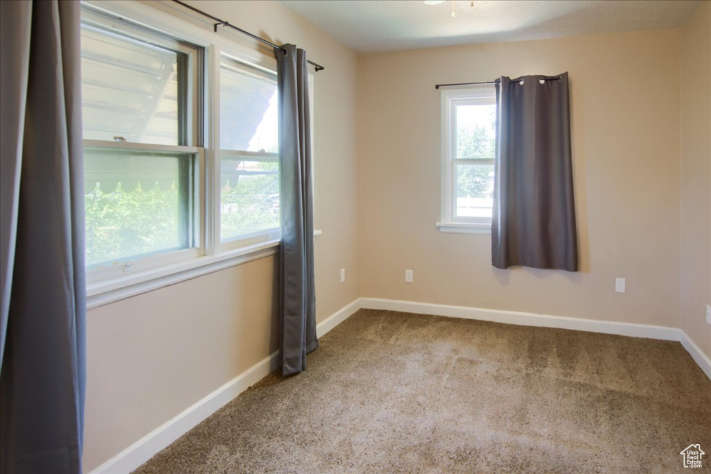 Carpeted spare room with baseboards