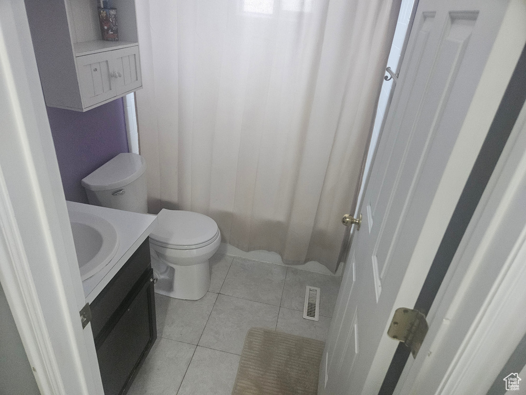 Bathroom with vanity, tile patterned flooring, and a shower with curtain