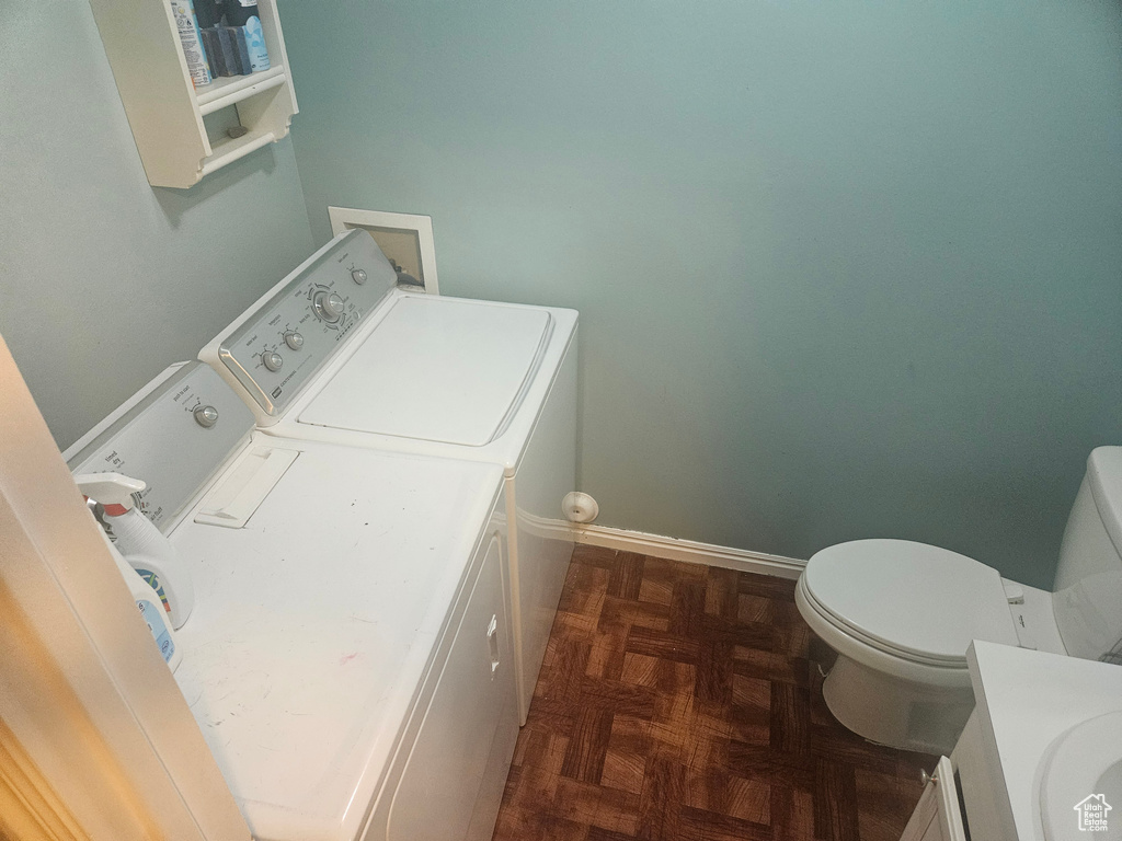 Washroom featuring separate washer and dryer and baseboards