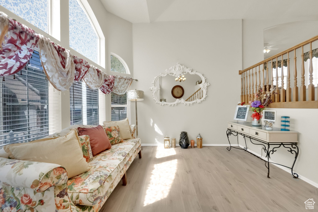 Living area featuring baseboards, wood finished floors, and ceiling fan