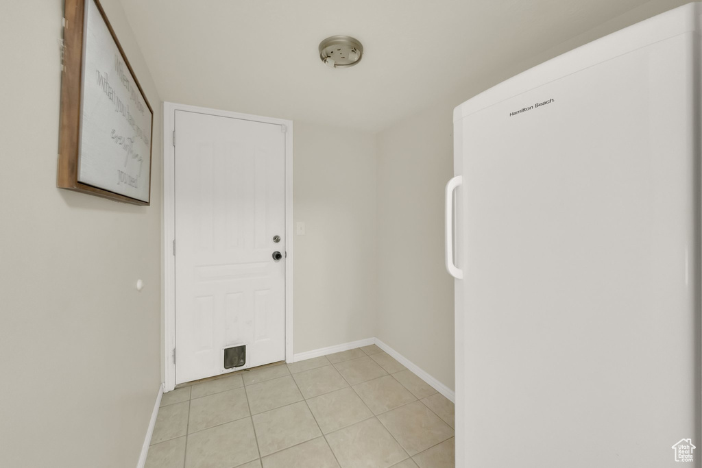 Interior space featuring light tile patterned floors and baseboards