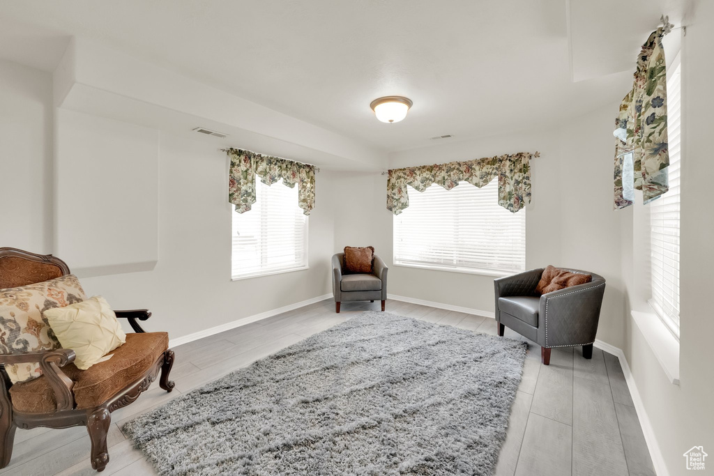 Living area featuring baseboards, visible vents, and wood finished floors
