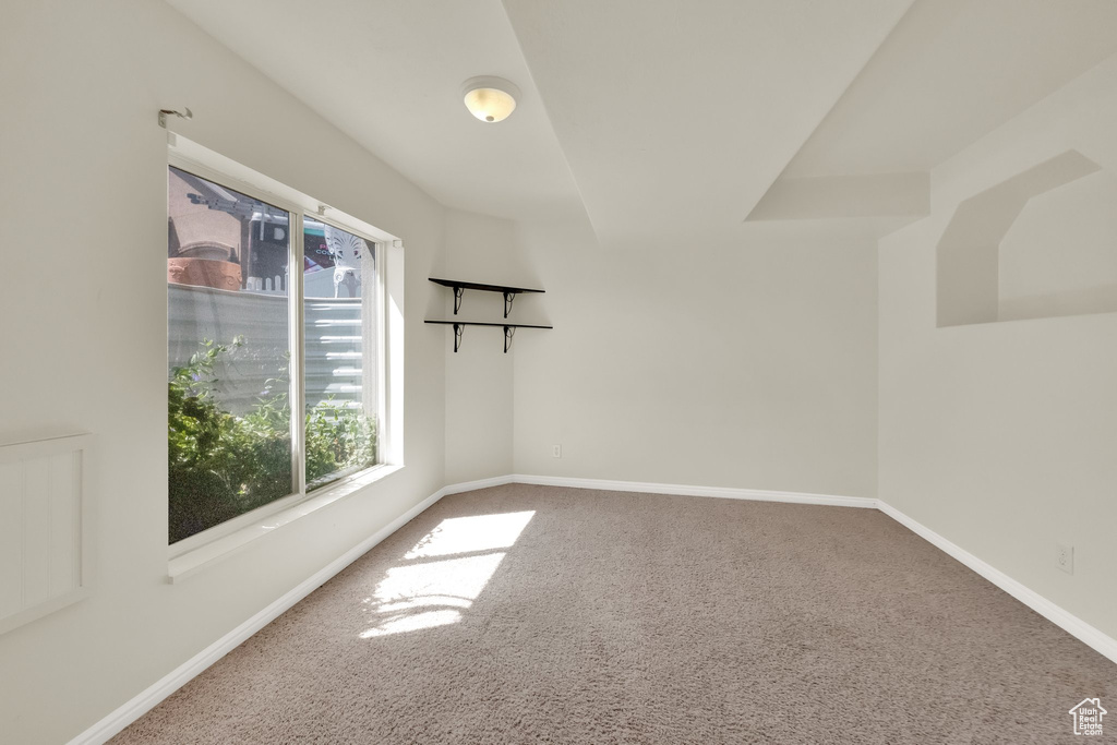 Unfurnished room with carpet and baseboards