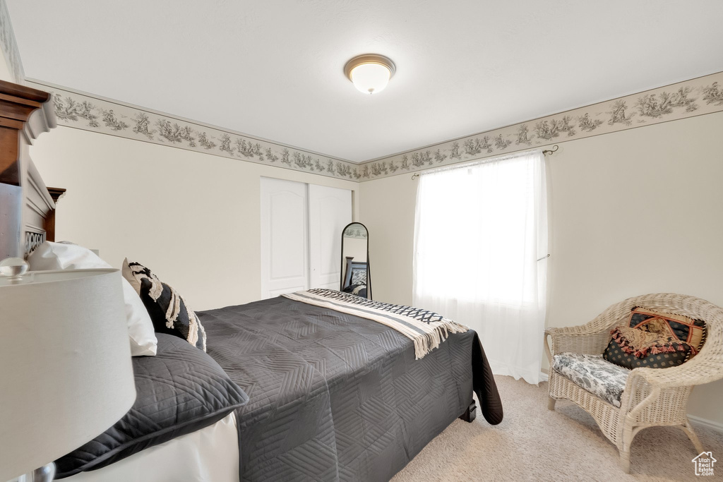 Bedroom featuring a closet and light carpet