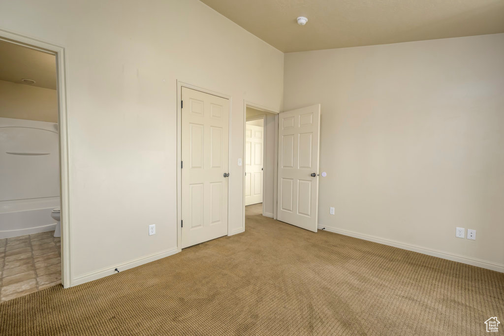 Unfurnished bedroom featuring carpet floors and baseboards