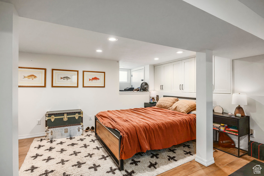 Bedroom featuring light wood-style floors, baseboards, and recessed lighting