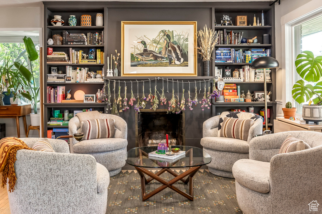 Sitting room featuring a tile fireplace and wood finished floors