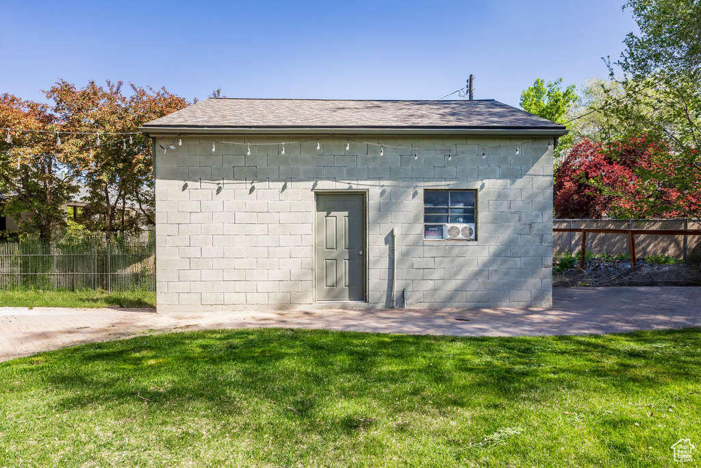 View of outbuilding with fence