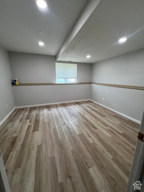 Basement featuring recessed lighting, baseboards, and wood finished floors