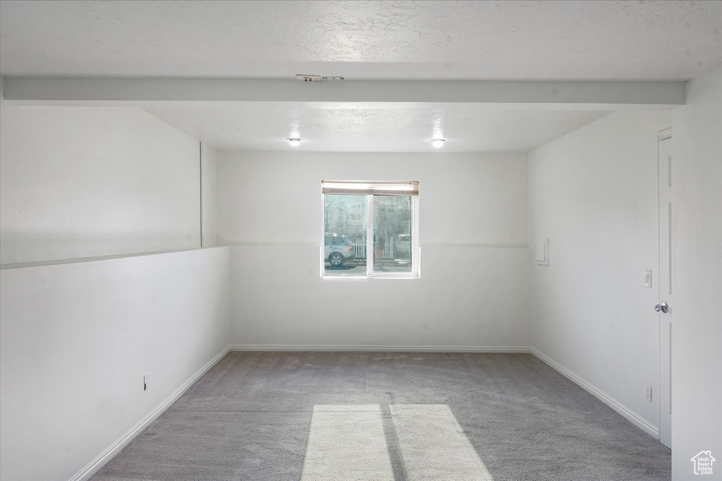 Carpeted empty room with baseboards