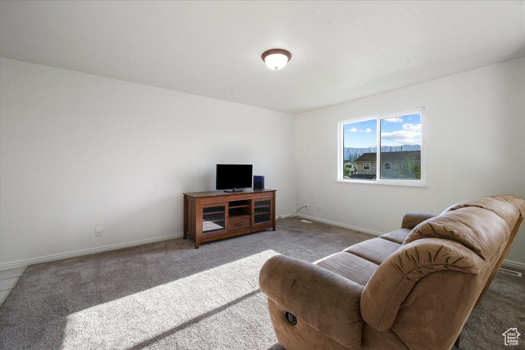 Living room featuring carpet floors, baseboards, and visible vents
