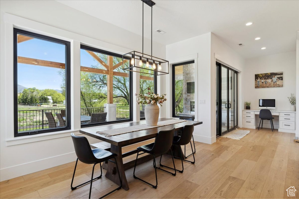 Dining space featuring baseboards, light wood-style floors, a chandelier, and recessed lighting