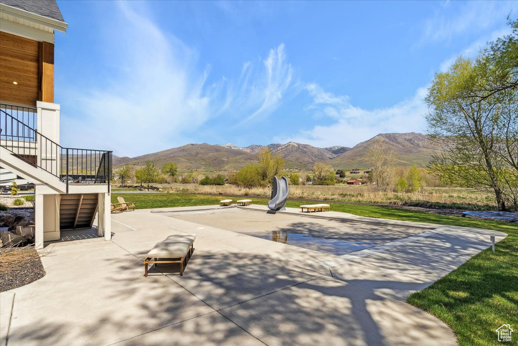 Surrounding community featuring a patio and a mountain view