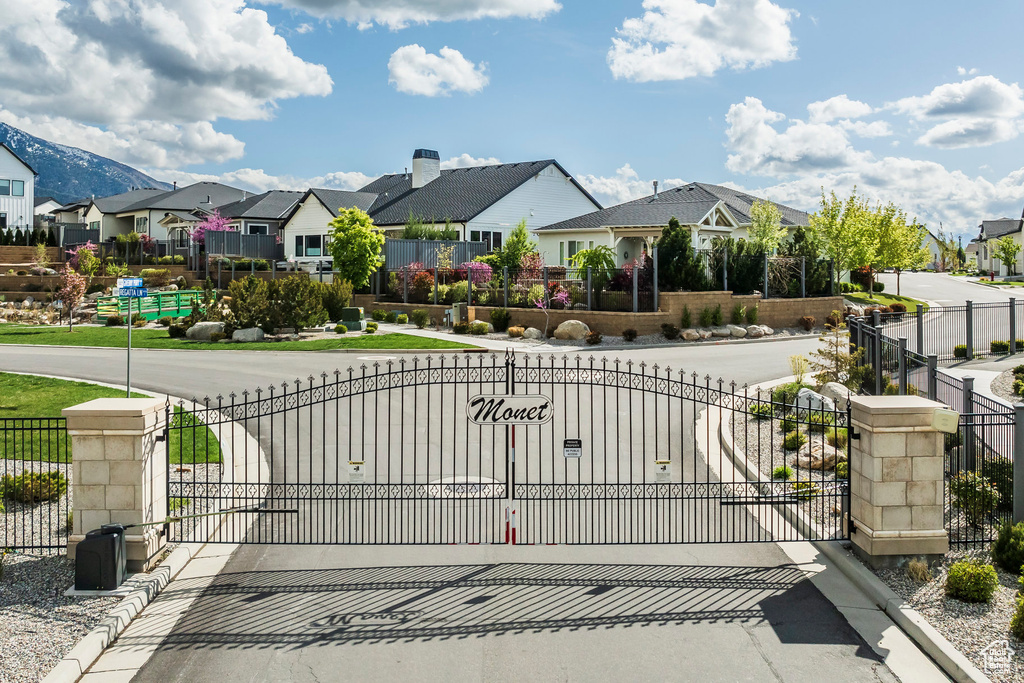 View of gate with fence and a residential view