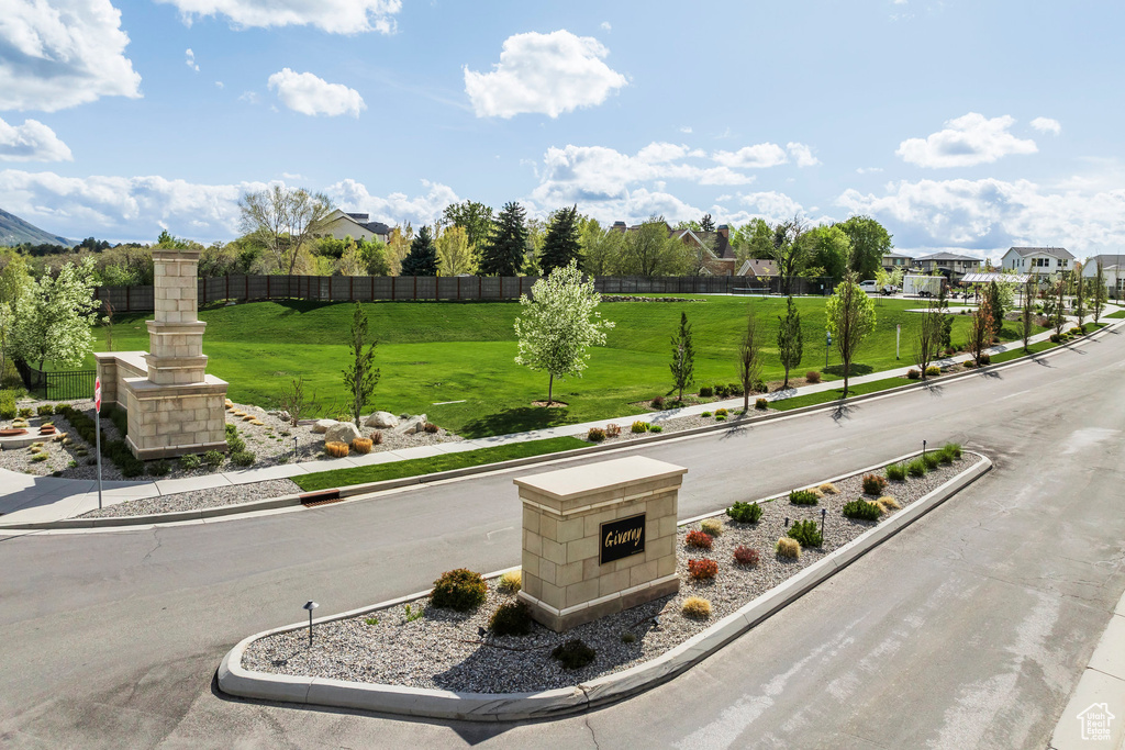 View of property's community with a yard, fence, and a residential view