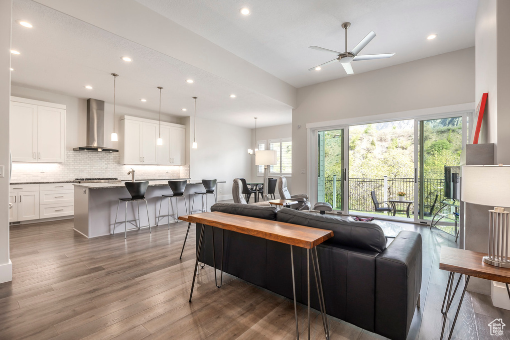 Living area with recessed lighting, ceiling fan, and wood finished floors