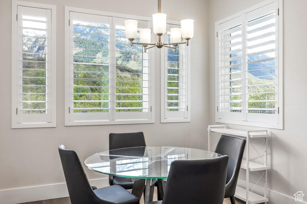 Dining space with a wealth of natural light and an inviting chandelier