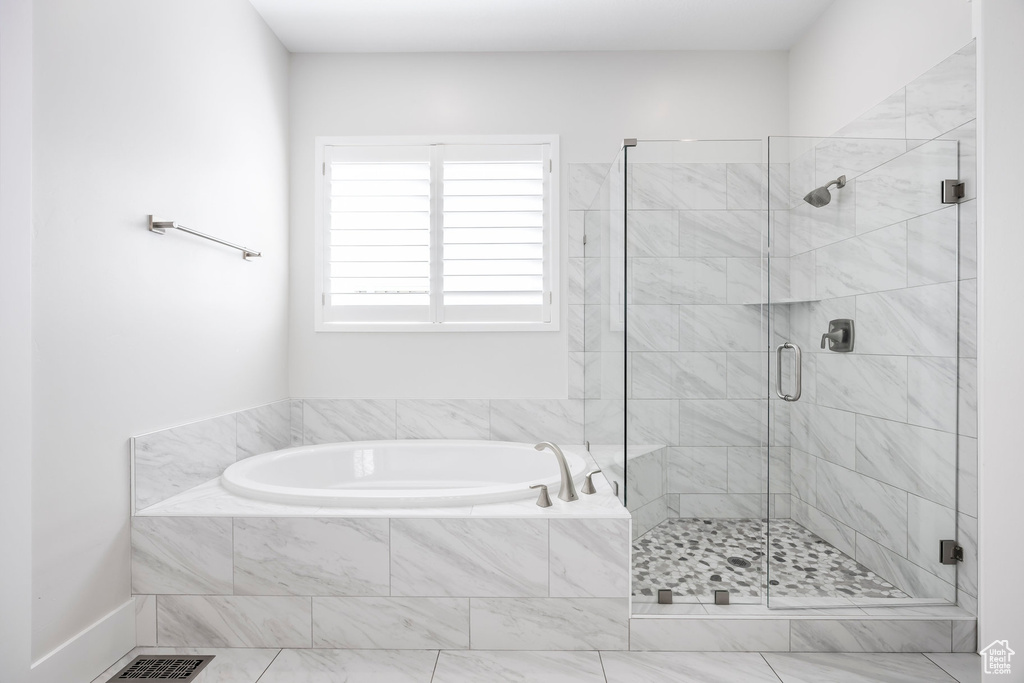 Full bath with a bath, visible vents, and a shower stall