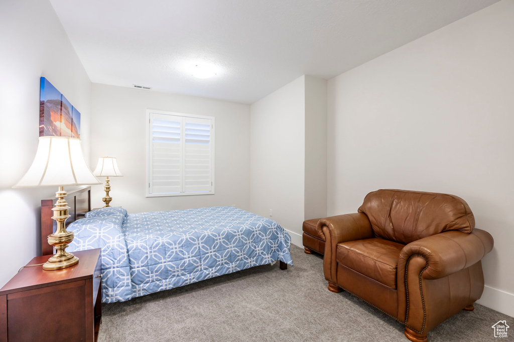 Carpeted bedroom with visible vents and baseboards
