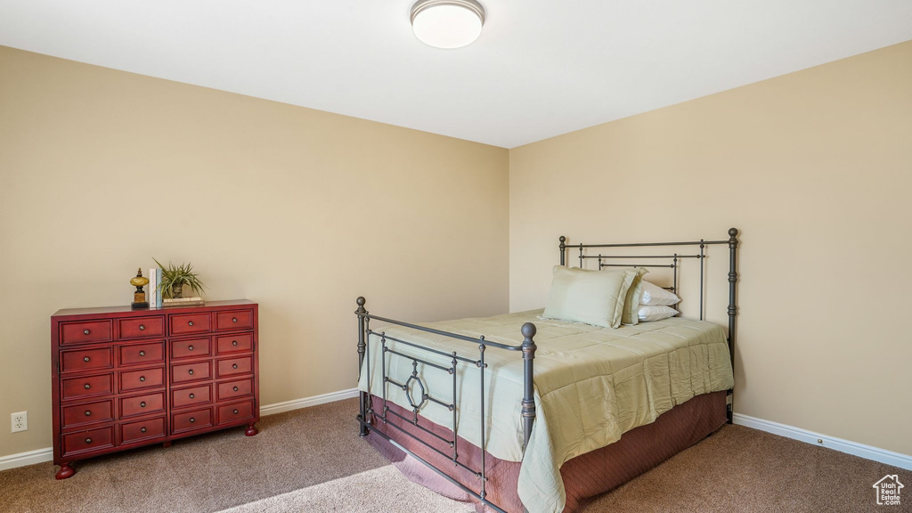 Bedroom with baseboards and carpet