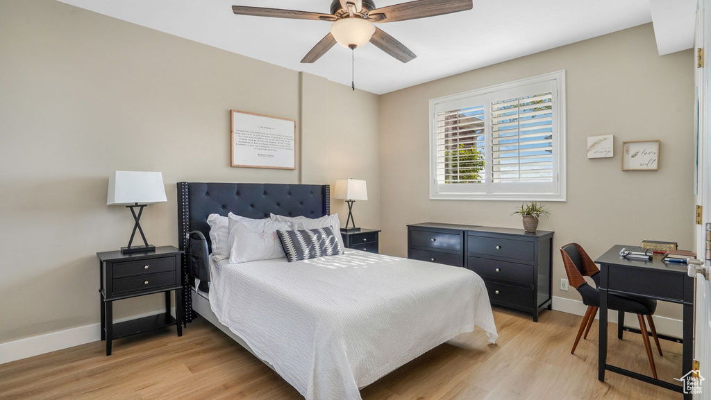 Bedroom featuring baseboards, light wood-style flooring, and ceiling fan