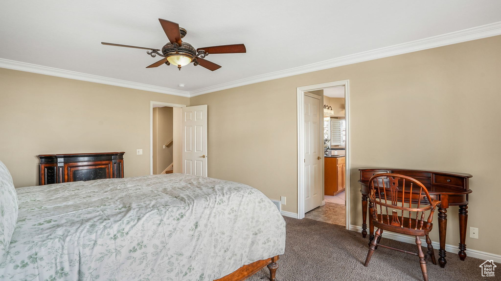 Bedroom with baseboards, ensuite bathroom, crown molding, and carpet floors
