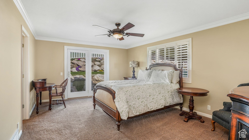 Bedroom featuring crown molding, baseboards, a ceiling fan, and carpet