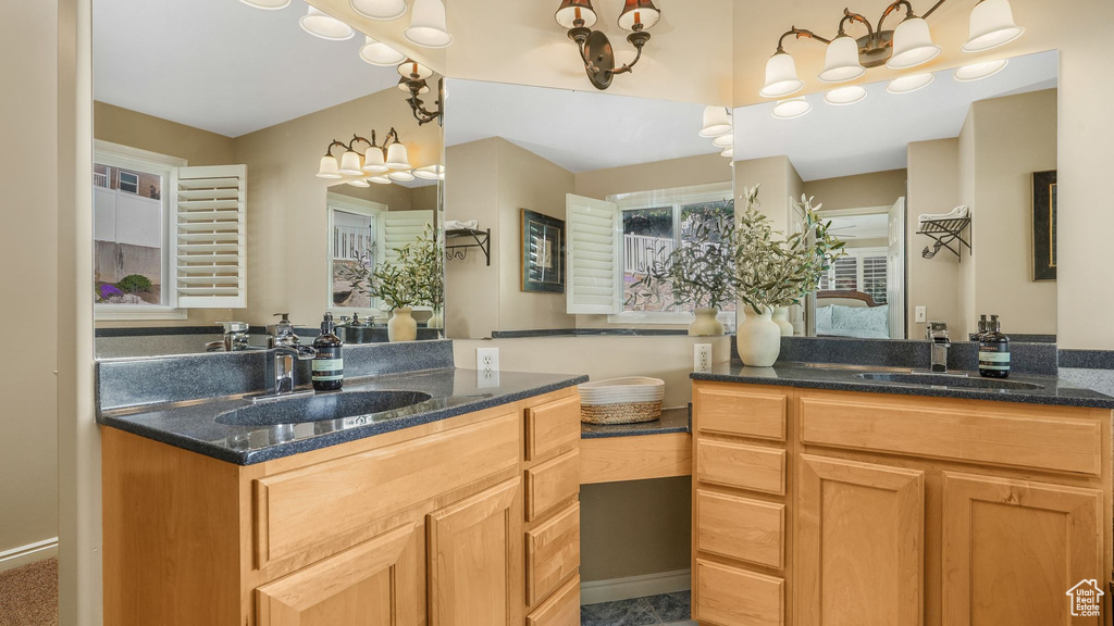Bathroom featuring a sink and two vanities