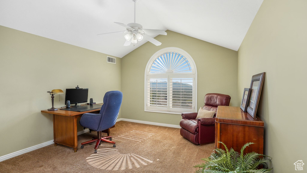 Carpeted office featuring a ceiling fan, baseboards, visible vents, and lofted ceiling