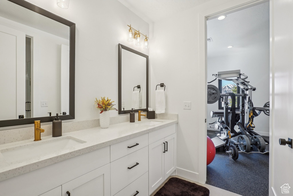 Full bathroom with recessed lighting, double vanity, and a sink