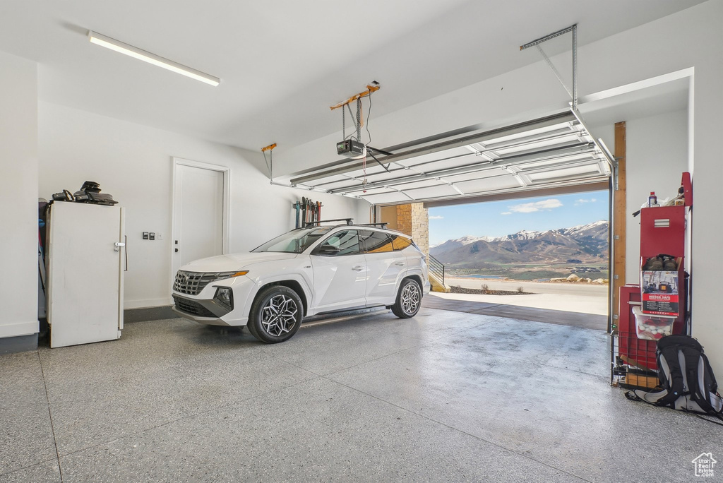 Garage featuring a mountain view and a garage door opener