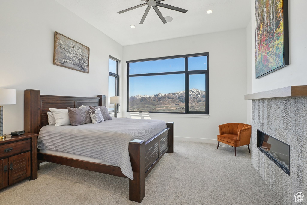 Bedroom featuring recessed lighting, a fireplace, ceiling fan, light carpet, and baseboards