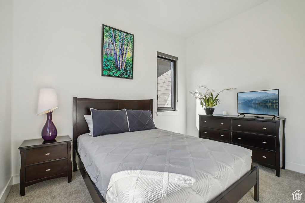Carpeted bedroom featuring baseboards