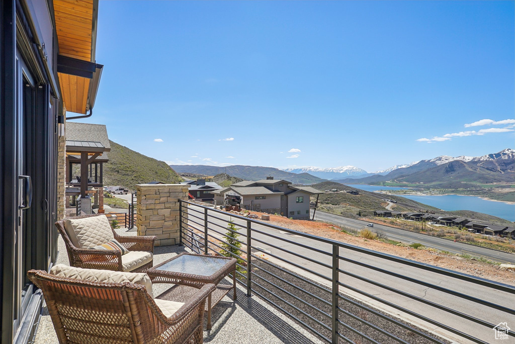 Balcony with a water and mountain view