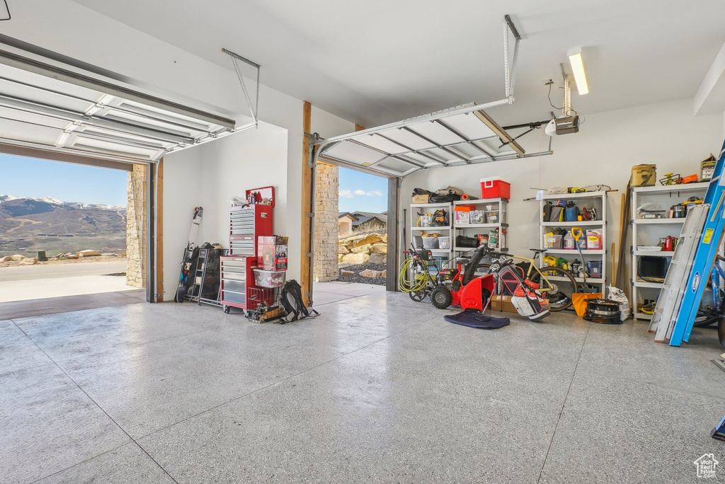 Garage with a mountain view and a garage door opener
