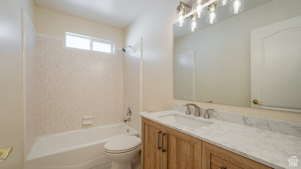 Full bath with washtub / shower combination, vanity, and toilet