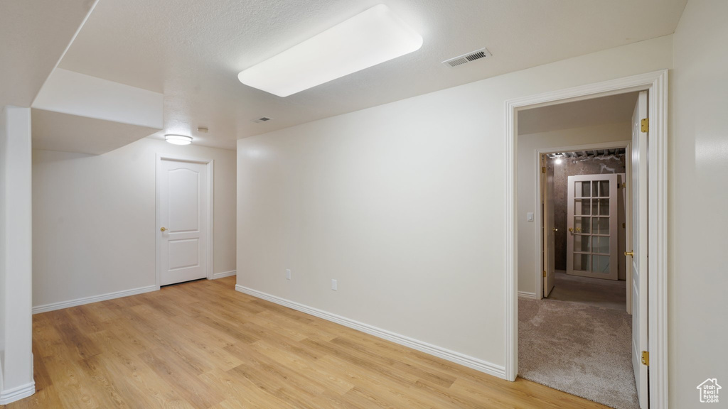 Spare room featuring baseboards, visible vents, and light wood-style flooring