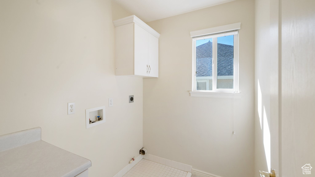 Laundry room with cabinet space, hookup for a washing machine, baseboards, hookup for a gas dryer, and electric dryer hookup